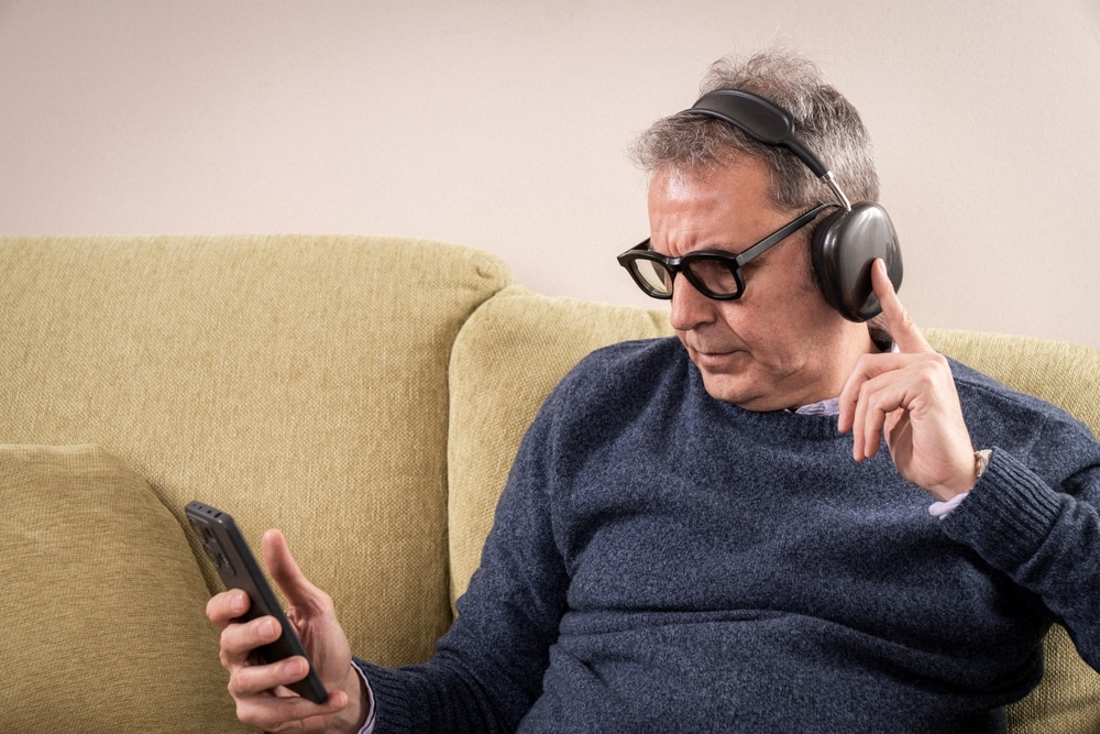 mature,man,with,eyes,closed,or,looking,down,,listening,to