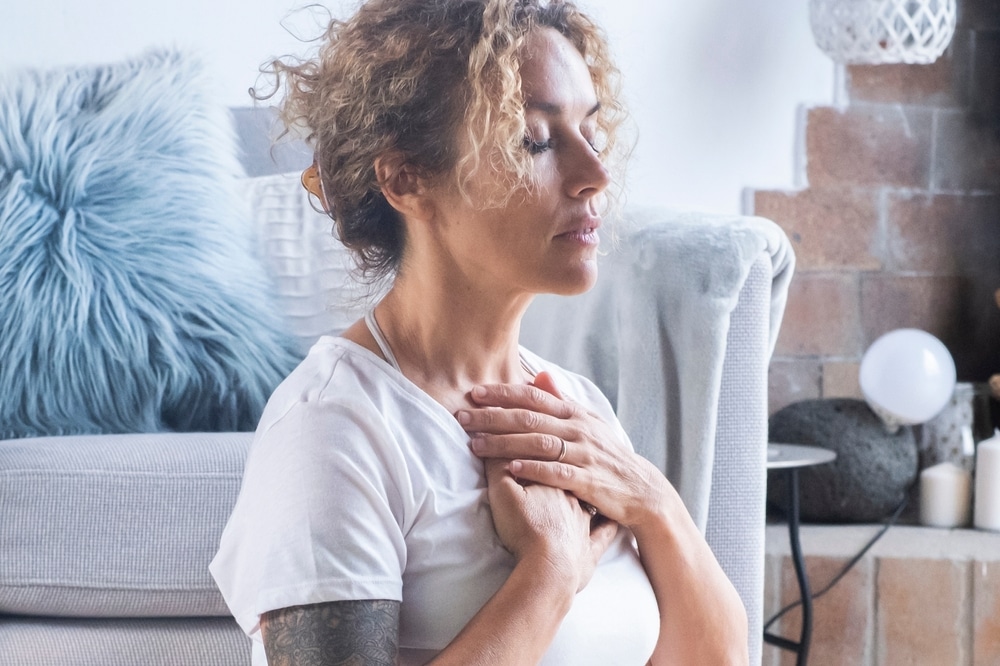 woman,at,home,meditating,in,lotus,position,,practicing,yoga,and