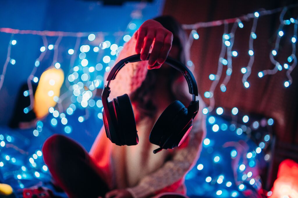 Cozy room ambiance with focus on a headset and vibrant LED lights creating a gaming mood.